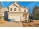Two-story house with beige siding, white garage door, and landscaping at 157 Parkview Place Dr, Mcdonough, GA 30253