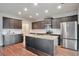 Island kitchen with dark cabinets and granite countertops at 157 Parkview Place Dr, Mcdonough, GA 30253