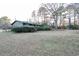 Backyard view with a shed and large grassy area at 2341 Amberbrook Sw Dr, Conyers, GA 30094