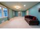 Spacious living room with light-colored carpet and teal walls at 2341 Amberbrook Sw Dr, Conyers, GA 30094