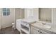 Bathroom with double vanity, marble countertop, and a soaking tub at 248 Billy Bullock Rd, Dallas, GA 30157