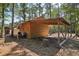 Wooden cabin with carport and wooded backdrop at 248 Billy Bullock Rd, Dallas, GA 30157
