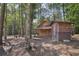 Wooden cabin and outhouse in a wooded setting at 248 Billy Bullock Rd, Dallas, GA 30157