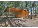 Wooden cabin with a carport and mature trees at 248 Billy Bullock Rd, Dallas, GA 30157