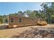 Brown mobile home with deck, steps, and stone base at 248 Billy Bullock Rd, Dallas, GA 30157