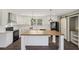 Modern kitchen with white cabinets, large island, and black appliances at 248 Billy Bullock Rd, Dallas, GA 30157