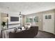 Virtually staged living room featuring a sofa, coffee table, and large TV at 248 Billy Bullock Rd, Dallas, GA 30157