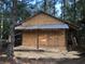 Wooden storage shed with metal roof in wooded area at 248 Billy Bullock Rd, Dallas, GA 30157