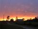 Vibrant sunset over field with barn in distance at 248 Billy Bullock Rd, Dallas, GA 30157