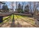 Fenced backyard with large lawn and patio area at 1429 Wood Iris Ln, Lawrenceville, GA 30045