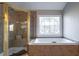 Bathroom boasts a large soaking tub and walk-in shower at 1429 Wood Iris Ln, Lawrenceville, GA 30045