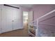 Bedroom with built in shelving and access to upper level at 1429 Wood Iris Ln, Lawrenceville, GA 30045