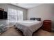 Bedroom with queen bed and window seating at 1429 Wood Iris Ln, Lawrenceville, GA 30045