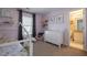 Bedroom with twin bed, dresser, and ensuite bath at 1429 Wood Iris Ln, Lawrenceville, GA 30045