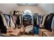 Large walk-in closet with ample hanging space at 1429 Wood Iris Ln, Lawrenceville, GA 30045