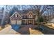 Brick front elevation of two story home with two car garage at 1429 Wood Iris Ln, Lawrenceville, GA 30045