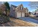 Brick home with two-car garage and landscaped yard at 1429 Wood Iris Ln, Lawrenceville, GA 30045