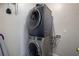 Stackable washer and dryer in a compact laundry room at 1429 Wood Iris Ln, Lawrenceville, GA 30045