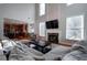 Open living room with kitchen views, hardwood floors, and sectional sofa at 1429 Wood Iris Ln, Lawrenceville, GA 30045