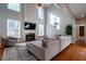 Bright living room featuring hardwood floors and a sectional sofa at 1429 Wood Iris Ln, Lawrenceville, GA 30045