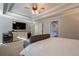 Main bedroom with TV, sitting area, and ensuite access at 1429 Wood Iris Ln, Lawrenceville, GA 30045