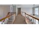 Upstairs hallway with wood and white railings at 1429 Wood Iris Ln, Lawrenceville, GA 30045