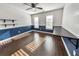 Spacious bedroom featuring a large blue accent wall, hardwood floors, ceiling fan, and desk at 1835 Wilkenson Xing, Marietta, GA 30066