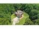 An aerial view of a secluded home surrounded by lush trees and a sprawling green lawn at 6020 Cochran Mill Rd, Chattahoochee Hills, GA 30268