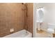 Cozy bathroom featuring a tiled shower, pedestal sink, and toilet, offering essential amenities in a compact space at 6020 Cochran Mill Rd, Chattahoochee Hills, GA 30268