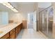 Bathroom features double vanity, large mirror, and tiled shower with glass door at 6020 Cochran Mill Rd, Chattahoochee Hills, GA 30268