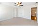 Bedroom with neutral walls and carpet, a ceiling fan and an attached closet at 6020 Cochran Mill Rd, Chattahoochee Hills, GA 30268