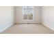 Bright bedroom featuring a large window offering a serene view of the outside, with plush carpeting throughout at 6020 Cochran Mill Rd, Chattahoochee Hills, GA 30268