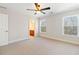 Spacious bedroom featuring neutral walls, plush carpeting, and natural light from two windows at 6020 Cochran Mill Rd, Chattahoochee Hills, GA 30268