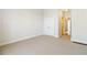 Inviting bedroom with carpet flooring, double closet, and access to the hallway; perfect for a cozy retreat at 6020 Cochran Mill Rd, Chattahoochee Hills, GA 30268