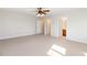 Large bedroom with neutral walls, plush carpet, ceiling fan and doors to bathroom and closet at 6020 Cochran Mill Rd, Chattahoochee Hills, GA 30268