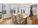 Bright dining area with a large table, chairs, and plenty of natural light from surrounding windows at 6020 Cochran Mill Rd, Chattahoochee Hills, GA 30268