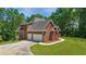 Spacious two-story brick home with a two-car garage and a large driveway at 6020 Cochran Mill Rd, Chattahoochee Hills, GA 30268