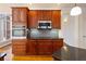 Gourmet kitchen with stainless steel appliances and custom wood cabinetry with plenty of storage at 6020 Cochran Mill Rd, Chattahoochee Hills, GA 30268