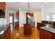 Gourmet kitchen featuring dark wood cabinetry, granite countertops, a kitchen island, and stainless steel appliances at 6020 Cochran Mill Rd, Chattahoochee Hills, GA 30268