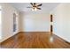 An empty living room featuring hardwood floors, neutral walls, and large windows at 6020 Cochran Mill Rd, Chattahoochee Hills, GA 30268
