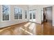 Sunlit living area with hardwood floors, multiple windows, and adjacent patio door at 6020 Cochran Mill Rd, Chattahoochee Hills, GA 30268