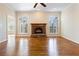 Spacious living room featuring a fireplace, hardwood floors, and large windows at 6020 Cochran Mill Rd, Chattahoochee Hills, GA 30268