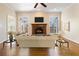 Comfortable living room featuring a fireplace, hardwood floors, and neutral color palette at 6020 Cochran Mill Rd, Chattahoochee Hills, GA 30268