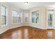 Bright room with hardwood flooring, multiple windows, and access to an outdoor deck at 6020 Cochran Mill Rd, Chattahoochee Hills, GA 30268