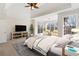 Bright main bedroom with sitting area, tray ceiling, large windows and TV console at 6020 Cochran Mill Rd, Chattahoochee Hills, GA 30268