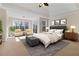 Spacious main bedroom featuring a tray ceiling, sitting area, and neutral decor at 6020 Cochran Mill Rd, Chattahoochee Hills, GA 30268