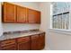 Pantry with custom cabinetry, counterspace, and a bright window looking out to the yard at 6020 Cochran Mill Rd, Chattahoochee Hills, GA 30268