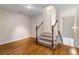 Carpeted staircase with hardwood floors and white trim leads to the upper level at 6020 Cochran Mill Rd, Chattahoochee Hills, GA 30268