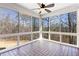 Inviting sunroom enclosed with large windows, featuring tiled flooring and a ceiling fan for year-round enjoyment at 6020 Cochran Mill Rd, Chattahoochee Hills, GA 30268