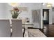Dining room boasts modern chandelier, glass table, and elegant decor, perfect for entertaining guests at 1250 Atherton Park, Roswell, GA 30076